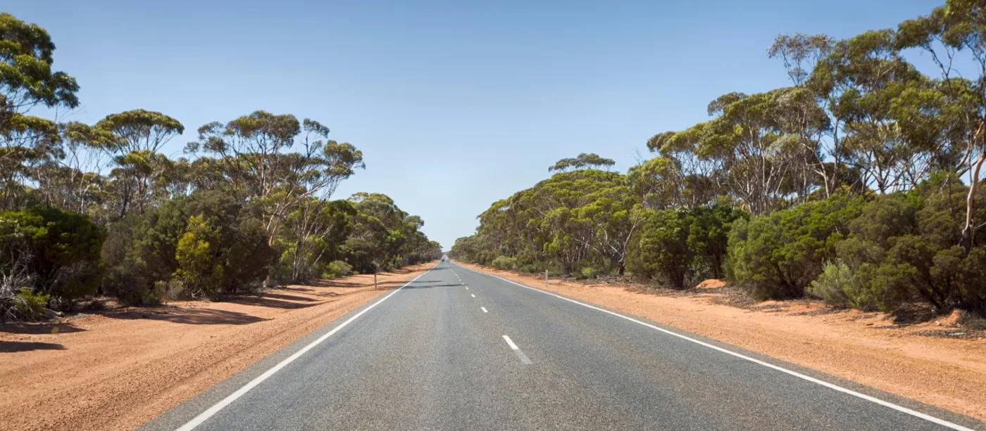 The long sealed highway through red dirt and gum country on the Goldfields run back to Perth