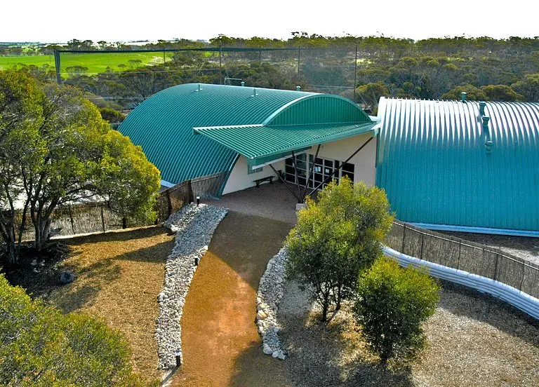 The modern Yongernow Malleefowl Centre building with its curved teal-green corrugated roof at Ongerup