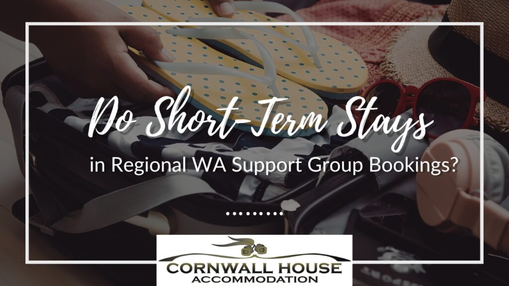 A close-up of hands packing a suitcase with vacation essentials like flip-flops and sunglasses for group stay