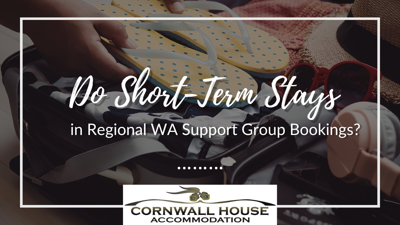 A close-up of hands packing a suitcase with vacation essentials like flip-flops and sunglasses for group stay